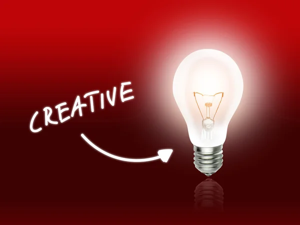 创造性的球泡灯节能灯红 — 图库照片