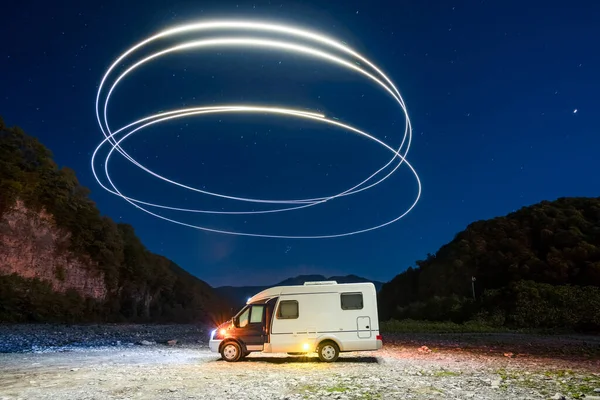 Motor home. Vacation in the mountains. The light cycles. Freez light. Camper. RV. Night. The stars in the sky.