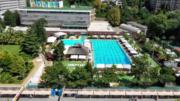 Aerial view on open swimming pool. Resort. Modern territory with open pools. Video from the top