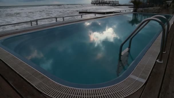 Zwembad met blauwe water op de achtergrond van een storm in de Zwarte Zee in Sotsji — Stockvideo