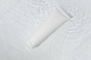 Su havuzu arka planında cilt sağlığı konsepti olan güzellik modası makyaj şişesi losyonu ürünü.