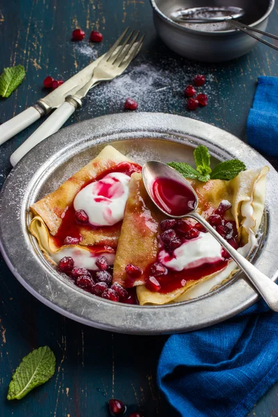 Crepe pancakes with cream and pomegranate  sauce — Stock Photo, Image