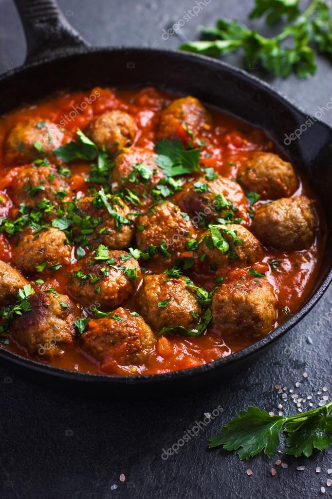 Beef meatballs with tomato sauce in pan Stock Photo by ©Anna_Shepulova