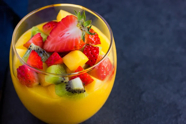 Mango smoothie with fruits and berries — Stock Photo, Image