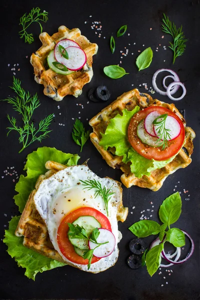 Savory waffle with cheese, ham, olives and herbs, served with fr — Stock Photo, Image