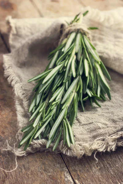 Rosemary bunch on a rustic background — Stock Photo, Image
