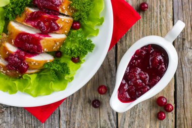 Roasted chicken breast with cranberry sauce for christmas dinner clipart