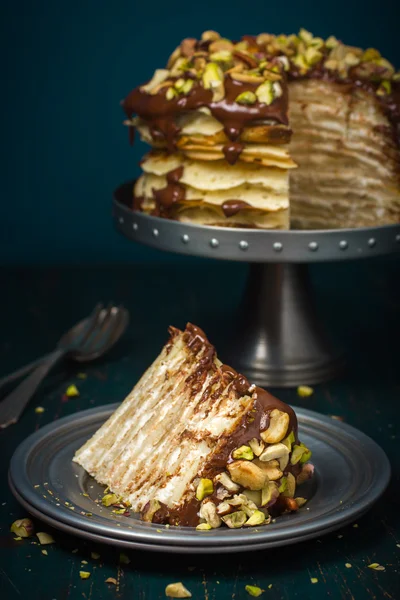 Crepe (pancakea) cake with chocolate and nuts