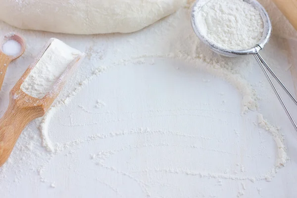 baking background.  Flour, bakeware and fresh dough