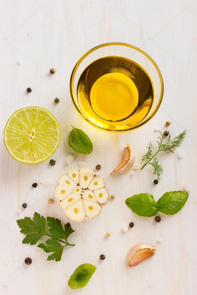 Ingrediets for salad dressing. Olive oil, garlic, lemon, herbs a Stock
