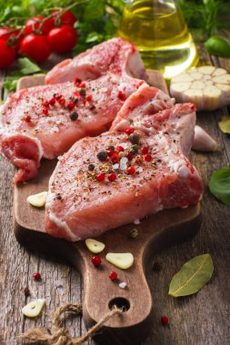 Pork chops with spices and herbs clipart