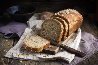 fresh  multigrain bread on rustic background clipart