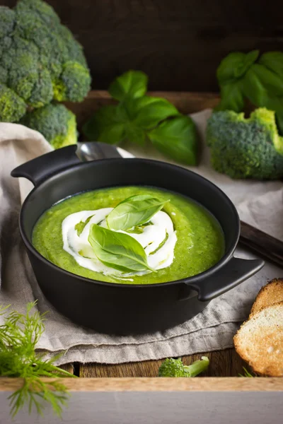 Broccoli cream soup on rustic background — Stock Image Broccoli cream soup on rustic background Stock Photo