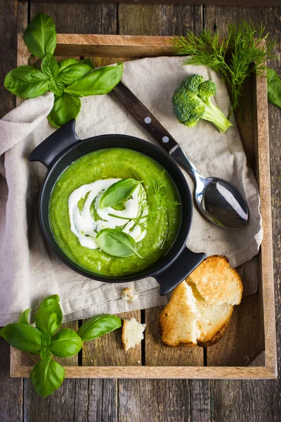 Broccoli cream soup on rustic background — Stock Image Broccoli cream soup on rustic background Royalty Free Stock Photos