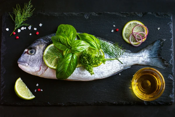 Fresh raw dorado fish with spices and herbs — Stock Photo, Image