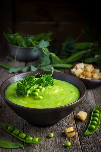 Green pea soup on rustic background — Stock Image Green pea soup on rustic background Stock Image