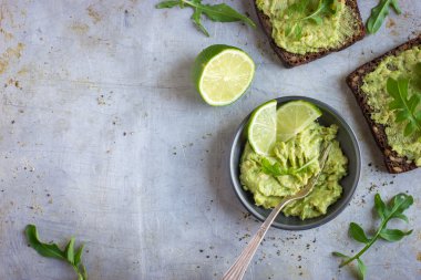  guacamole and rye toasts on rustic  background clipart