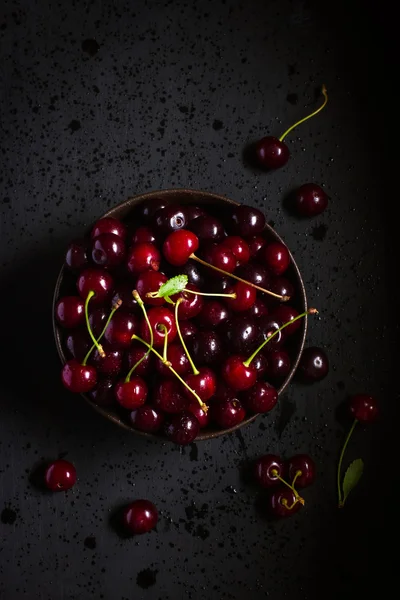 Cereja fresca em tigela preta — Fotografia de Stock