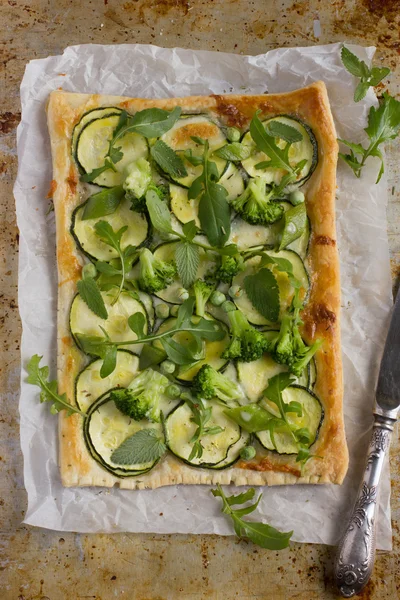 Vegetarian puff pie with zucchini, broccoli and green peas. — Stock Photo, Image