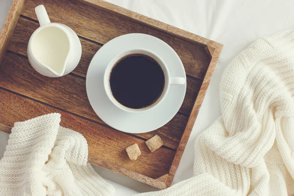 Cup of coffee, cream and brown sugar on wooden tray — Stock Image Cup of coffee, cream and brown sugar on wooden tray Stock Photo