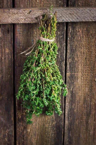 Thyme bunch on an old wooden background — Stock Photo, Image
