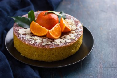 tangerine and almond cake on dark blue background,  clipart