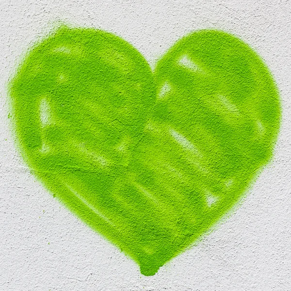 A big green heart, painted on the wall with spray paint.