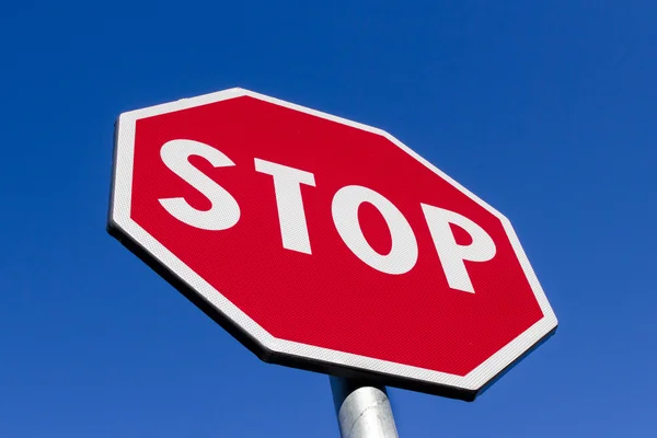 Stop sign against deep blue sky — Stock Photo, Image