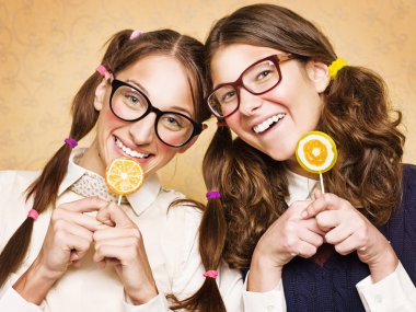 Young female nerds with lollypops clipart