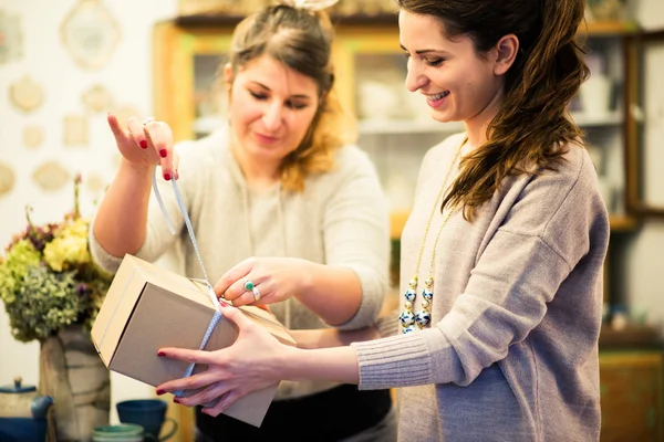 Dos mujeres embalaje regalos — Foto de Stock