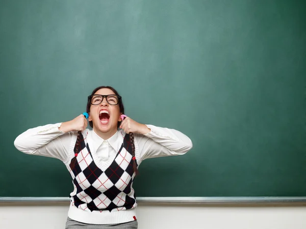 Female nerd yelling in front of the blackboard — Stock Photo, Image