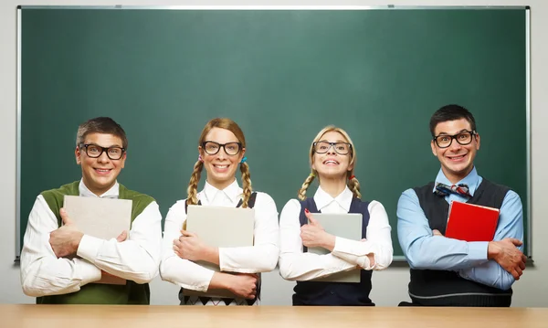 Four nerds holding books — Stock Photo, Image