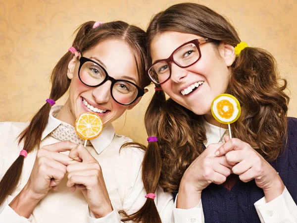 Young female nerds with lollypops — Stock Photo, Image
