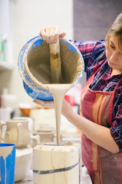 Pottery artist pouring clay — Stock Photo, Image