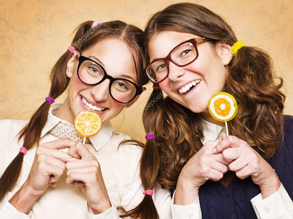 Young female nerds with lollypops