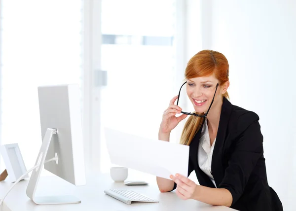 Businesswoman looking into papers — Stock Photo, Image