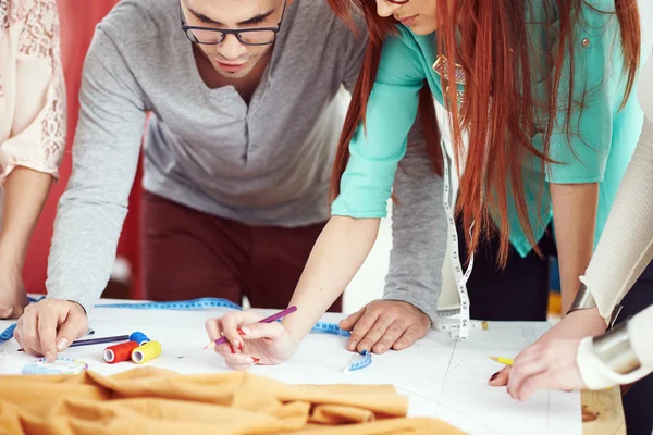 Designers debating over sewing pattern — Stock Photo, Image