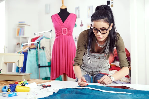 Designer measuring textile material — Stock Photo, Image