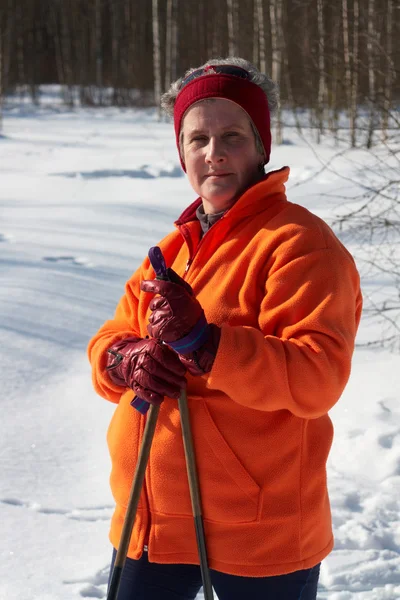 Senior woman cross country skier in forest on sunny day — Stock Photo, Image