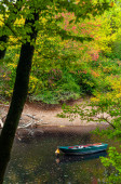 Картина, постер, плакат, фотообои "mannheim, germany. october 4th, 2009. boat in the river in an autumn landscape in the "waldpark", the park near the river rhine. ", артикул 430040750