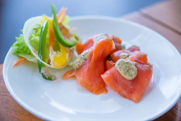 Smoked salmon in a dish on the table. — Stock Photo, Image