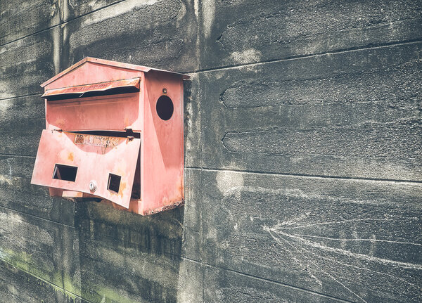 Old steel red mailbox hang on the wall