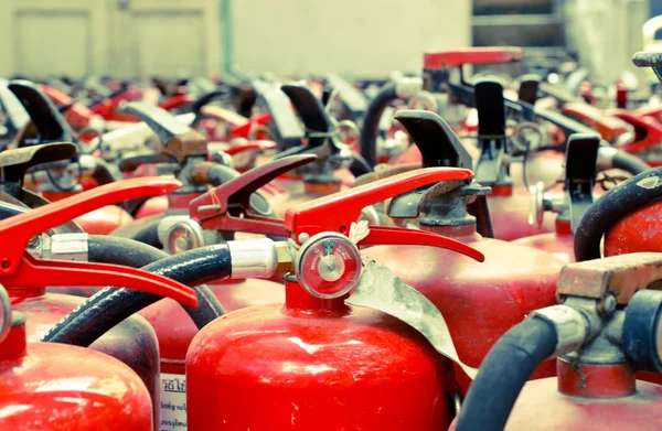 The fire extinguisher used. background with a lot of fire extinguishers — Stock Photo, Image