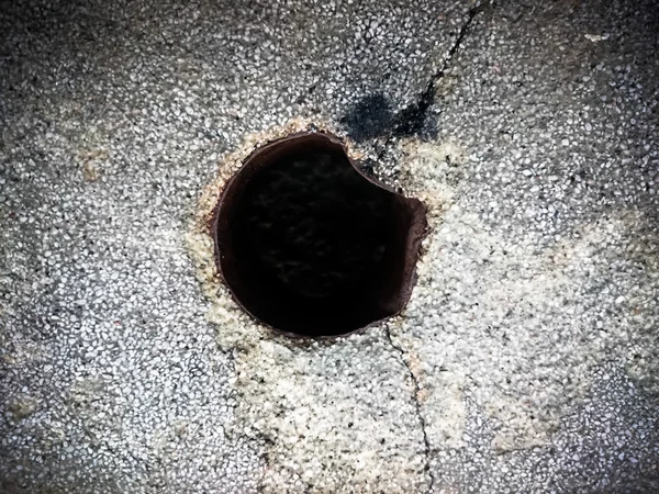 Black hole in cracked floor — Stock Photo, Image