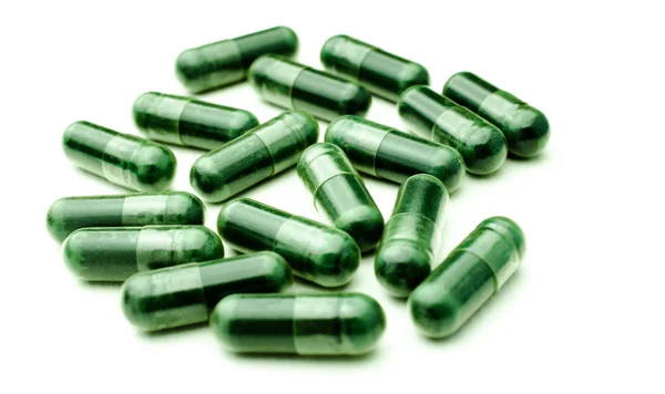 Pilules médicales sur fond blanc, mise au point sélective, isolé — Photo
