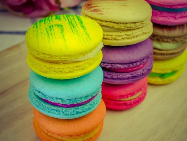 Colorful macarons on wooden background — Stock Photo, Image