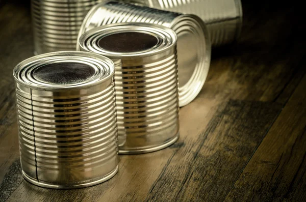 Tin cans for food on wooden background — Stock Photo, Image