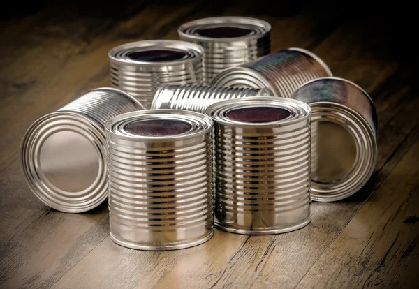 Tin cans for food on wooden background — Stock Photo, Image