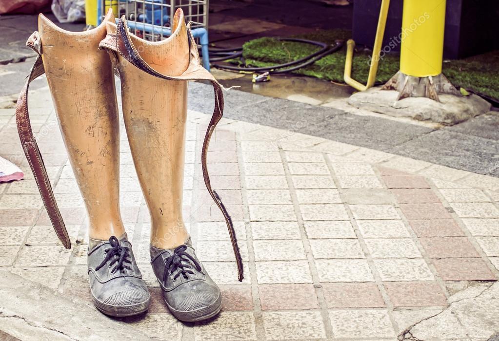 Old prosthetic legs set on a cement floor
