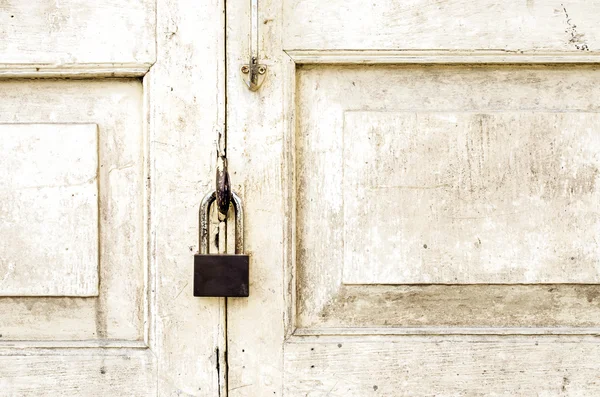 Old rusted lock on old white door — Stock Photo, Image